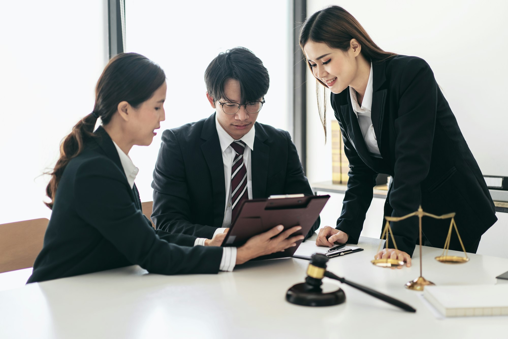 Female lawyer giving advice law and agreement of contract to client while business team reading