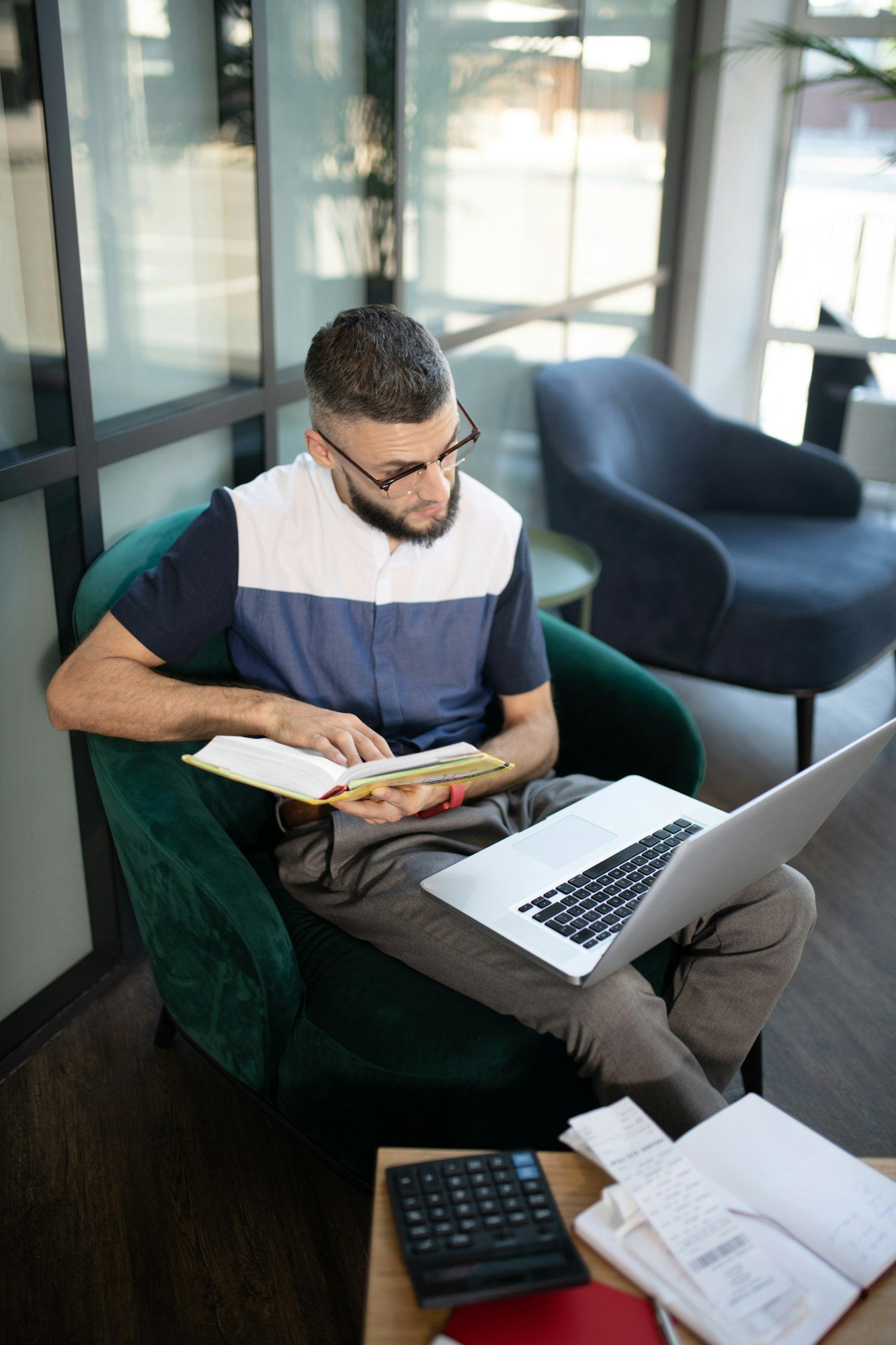 Young businessman studying law and analyzing expenses